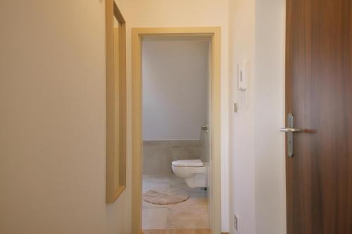 an open door to a bathroom with a toilet at Prague Expat House in Prague