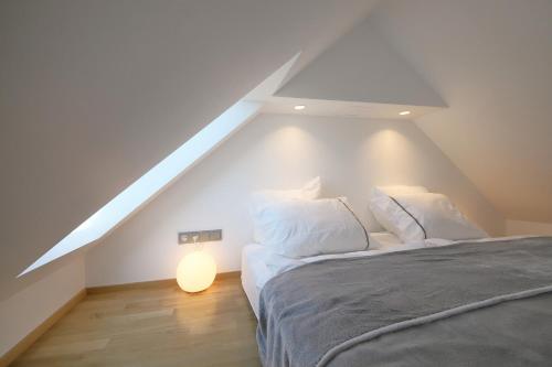 a attic bedroom with a bed and a white roof at Prague Expat House in Prague