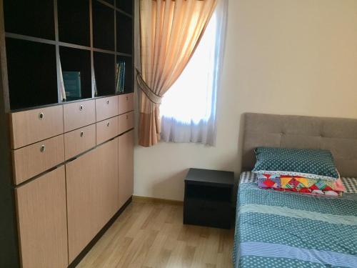 a small bedroom with a bed and a window at The oasis in Kuching