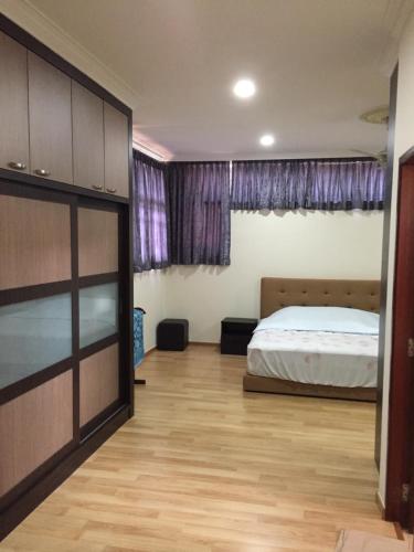 a bedroom with a bed and a wooden floor at The oasis in Kuching