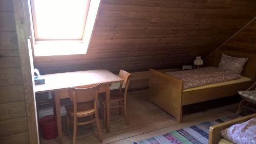 a small room with a table and a bed at Kovářův mlýn in Stachy