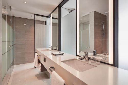 a bathroom with a sink and a mirror at Ramada Encore by Wyndham Gimpo Han River Hotel in Gimpo