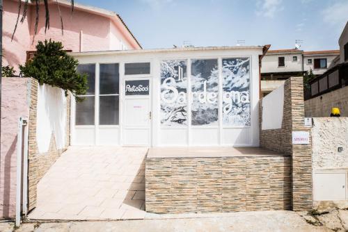 a house with a white door with a sign on it at Villa Diana affitta camere in Stintino