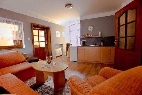 a living room with a couch and a table at Hotel Paradies in Teplice