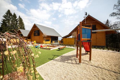 a playground in front of a log cabin at Chaty Ferrata in Martin