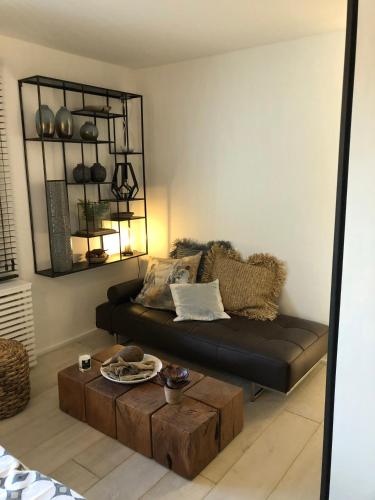 a living room with a couch and a coffee table at L'Oisette in Ghislenghien