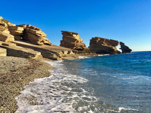 a group of rocks on the shore of the ocean at Villa Thalassa in Triopetra