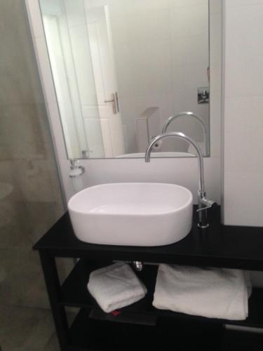 a white sink in a bathroom with a mirror at Villa Thalassa in Triopetra