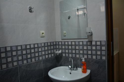 a bathroom with a sink and a mirror at Hotel Central in Kutaisi
