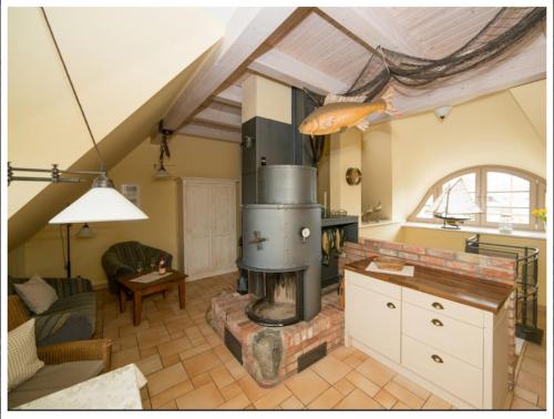 a living room with a fireplace in the middle of a room at "Netzboden" by Ferienhaus Strandgut in Born