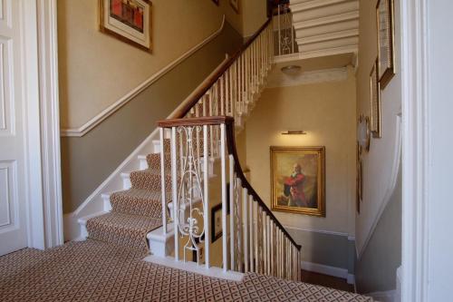 a staircase in a home with a painting on the wall at Dukes Bath in Bath