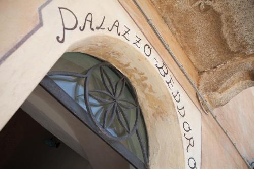an entrance to a building with a window at Palazzo Beddoro in San Pantaleo