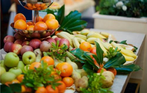 a table topped with lots of fruits and vegetables at Hotel Mirta - San Simon Resort in Izola
