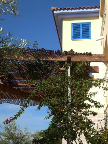 a building with a tree and a building with a window at Hotel Mayarí Boutique Hotel in Calabardina