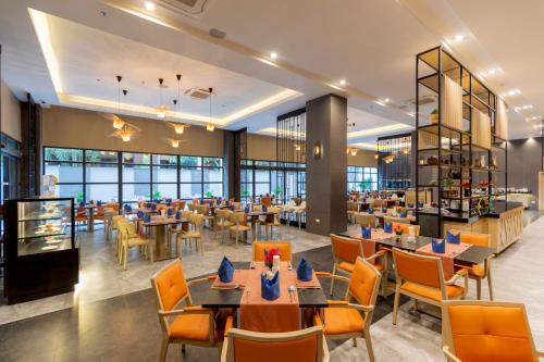 a restaurant with tables and chairs and a cafeteria at WOOVO Phuket Patong - by Swandor in Patong Beach