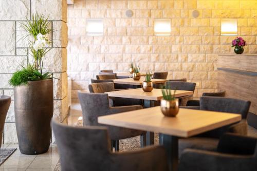 a row of tables and chairs in a restaurant at Hotel Mirta - San Simon Resort in Izola