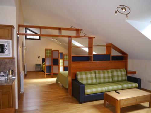 a living room with a couch and a bunk bed at Villa Russell Hotel&Apartments in Torla