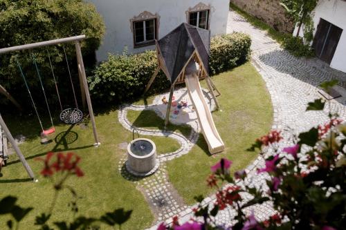 a small garden with a playground and a swing at Pension Ober in Siegsdorf