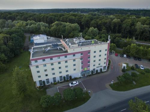 an overhead view of a building with a parking lot at Campanile Poznan in Poznań