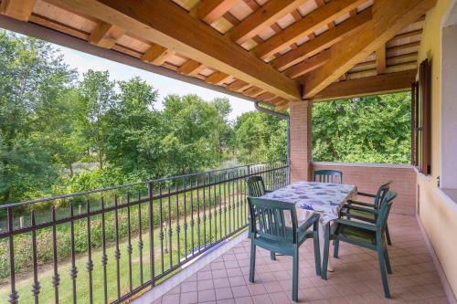 a patio with a table and chairs on a balcony at Agriturismo Tenuta Regina - Glamping luxury lodges and apartments in Palazzolo dello Stella