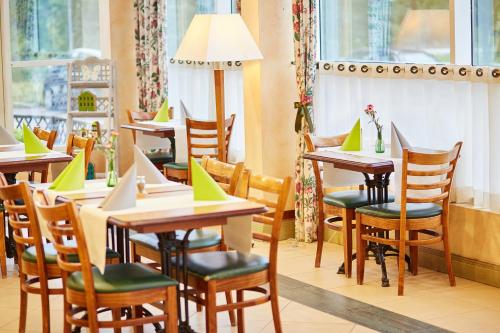 a restaurant with tables and chairs and windows at Campanile Poznan in Poznań