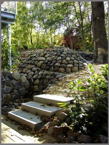 a stone wall with steps in front of a building at Hotel zwischen den Seen in Waren