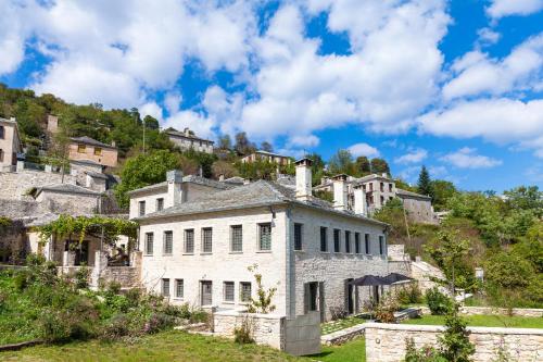 an old house on a hill with houses at "Apeiros Chora" Hotel, Zagori in Kato Pedina