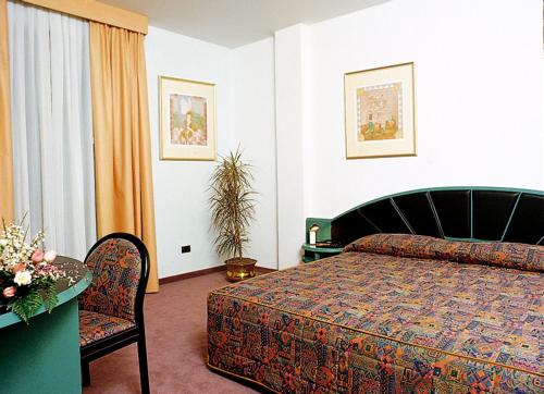 a bedroom with a bed and a table and a chair at Antica Postumia in Vedelago