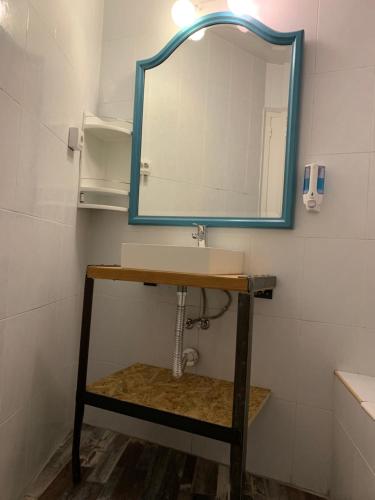 a bathroom with a sink and a mirror at Hostal Portugal in Barcelona