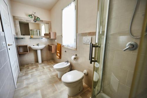 a bathroom with a toilet and a sink at Trullo Felice in Ostuni