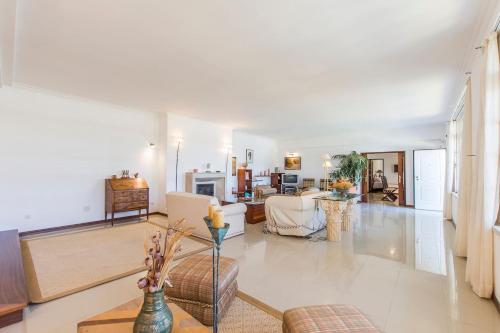 a living room with a couch and a table at Villa Maia in Corroios