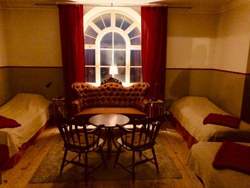 a living room with a chair and a window at Soldatens Bed & Breakfast in Marstrand