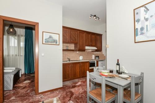 a kitchen with a table and a dining room at V & G Cozy Apartments in Kissamos