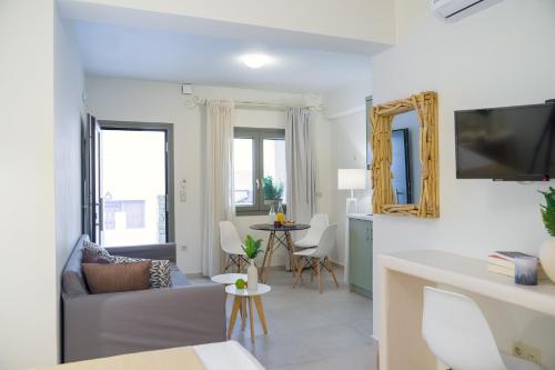 a living room with a couch and a table at Sweet Home Naxos in Naxos Chora