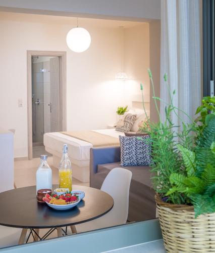 a living room with a bed and a table with a bowl of fruit at Sweet Home Naxos in Naxos Chora