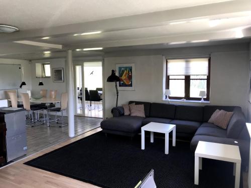 a living room with a couch and a table at Tingvej 15 Feriehus in Aabenraa