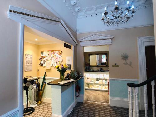 a shop with a vase of flowers on a counter at Glenorleigh in Torquay