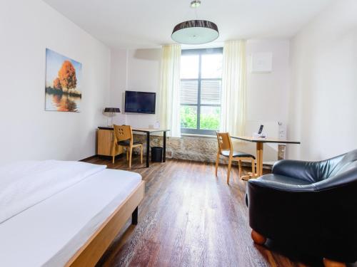 a bedroom with a bed and a table and chairs at historic Apart in Erlangen