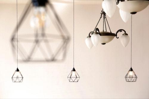 a group of lights hanging from a ceiling at Hotel Zámeček Janovičky in Broumov