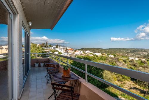 a balcony with chairs and tables and a view at Thomas Hotel in Monólithos