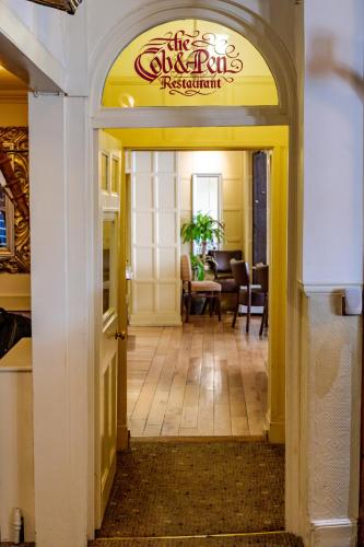 an entry way to a restaurant with a dining room at Swan Revived Hotel in Milton Keynes