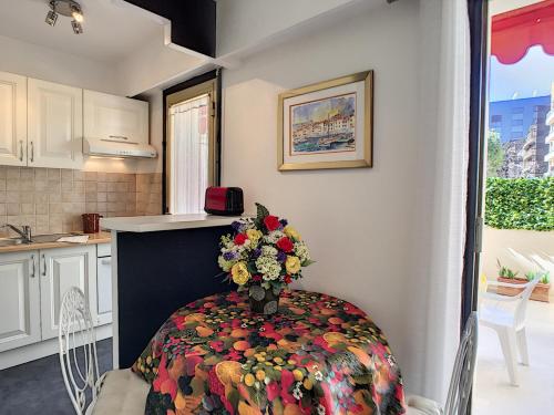 une cuisine avec une table avec un vase de fleurs dessus dans l'établissement Nestor&Jeeves - LE FRANCE TERRASSE - Central - Very close sea, à Nice