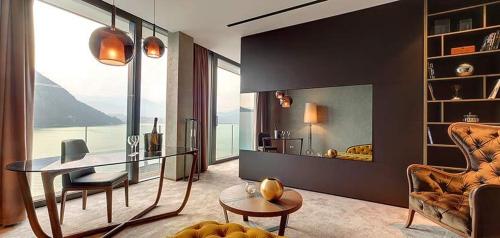 a living room with a table and a chair at Grand Hotel Campione in Campione dʼItalia