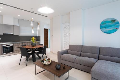 a living room with a couch and a table at NAPA GEM SUITES by LUXEL VILLAS in Ayia Napa