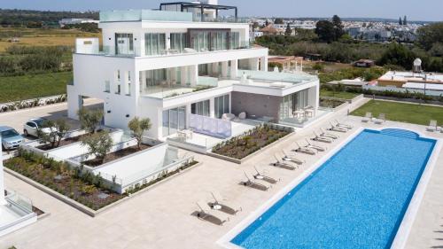 an aerial view of a villa with a swimming pool at NAPA GEM SUITES by LUXEL VILLAS in Ayia Napa