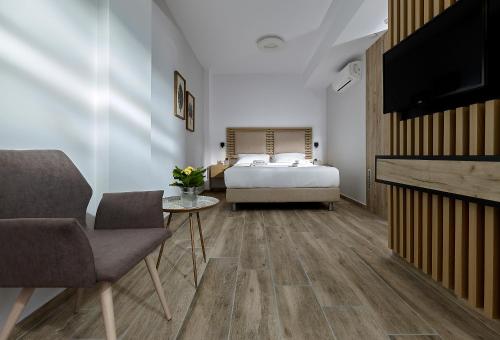 a bedroom with a bed and a tv and a fireplace at Seascape Luxury Residences in Agia Pelagia