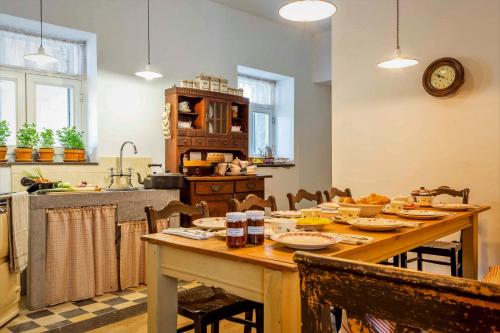 a kitchen with a table with food on it at B&B Hostellerie Marie in Eben-Emael