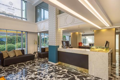 a lobby with a reception desk in a building at Airotel Stratos Vassilikos Hotel in Athens