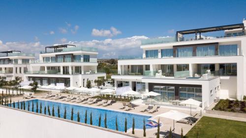 an aerial view of a resort with a swimming pool at NAPA GEM SUITES by LUXEL VILLAS in Ayia Napa