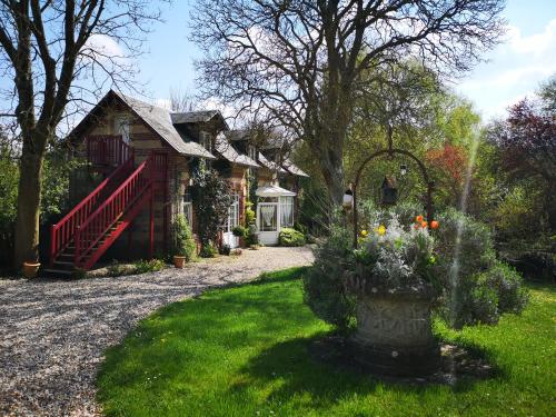 a house with a fountain in front of a yard at Le Domaine des Prés du Hom in Bézu-Saint-Éloi
